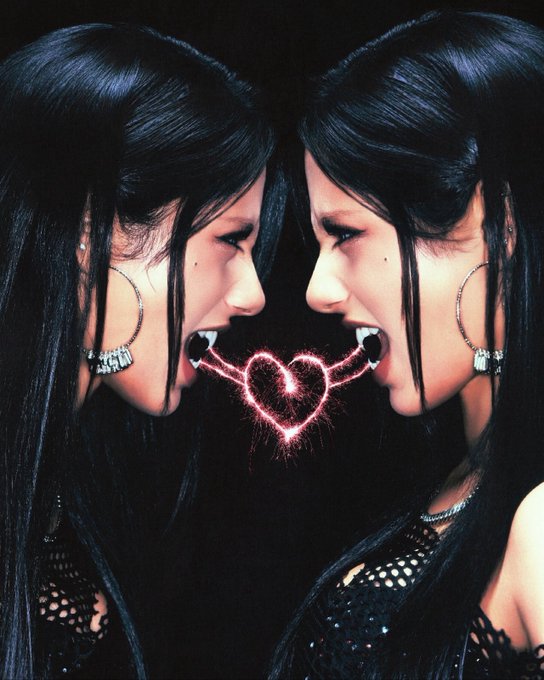Two women with long dark hair and hoop earrings face each other in profile, sharing a glowing pink heart between their mouths.