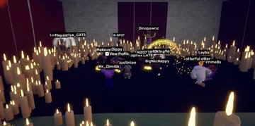 A Roblox game scene featuring player avatars gathered in a dark room illuminated by many floating candles.
