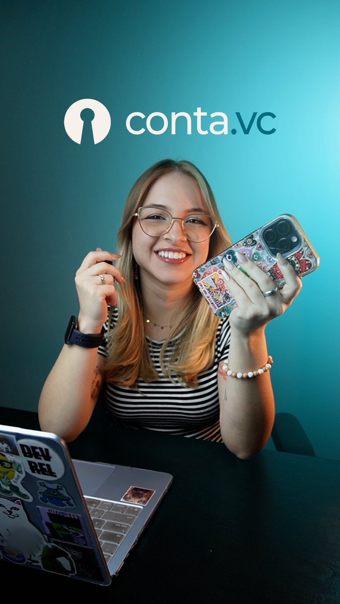 A smiling woman with glasses holds up a sticker-covered phone case in front of a teal background featuring the 'conta.vc' logo.