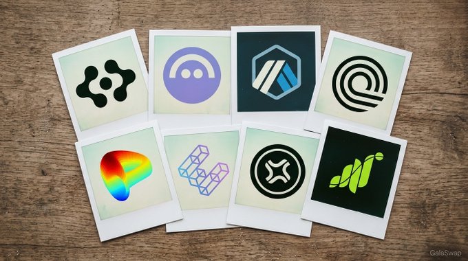 Eight Polaroid-style cards arranged on a wooden surface display logos representing various cryptocurrency tokens, including the colorful heart-shaped FET logo, alongside other project icons featured on the GalaSwap trading platform.