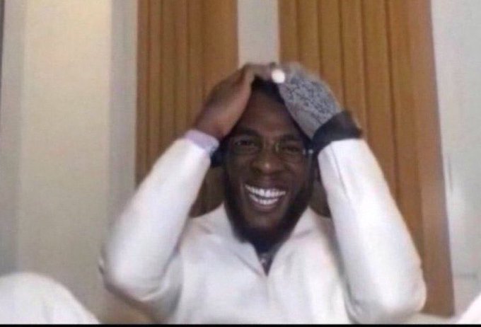 Reaction meme image of a smiling Black man with glasses wearing a beanie, holding his head in his hands in an expression of overwhelming excitement or disbelief.