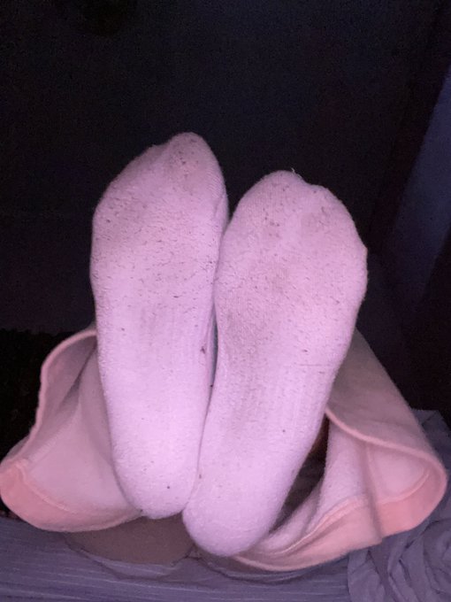 A close-up view of two pink foam shoe soles resting on a surface.