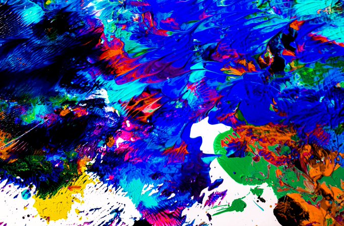 An abstract, chaotic painting filled with vibrant, overlapping brushstrokes in shades of blue, red, green, yellow, and black.