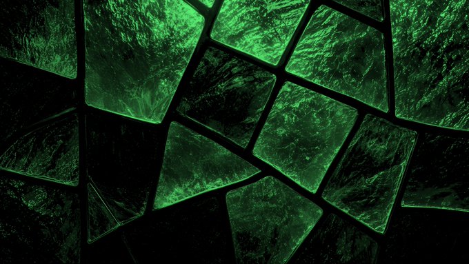A digital artwork featuring a mosaic of irregular geometric tiles in shades of dark and bright green, resembling cracked glass or polished stones.