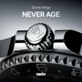 A close-up image of a luxury watch on a metal bracelet with the text 'NEVER AGE' overlaid.