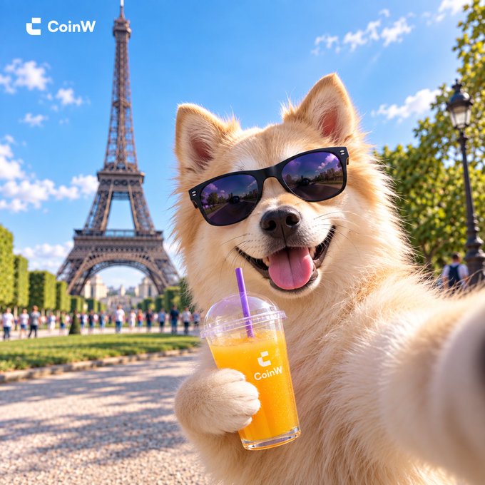 A smiling dog wearing sunglasses holds a 'CoinW' branded orange drink in front of the Eiffel Tower, with the 'CoinW' logo visible in the corner.