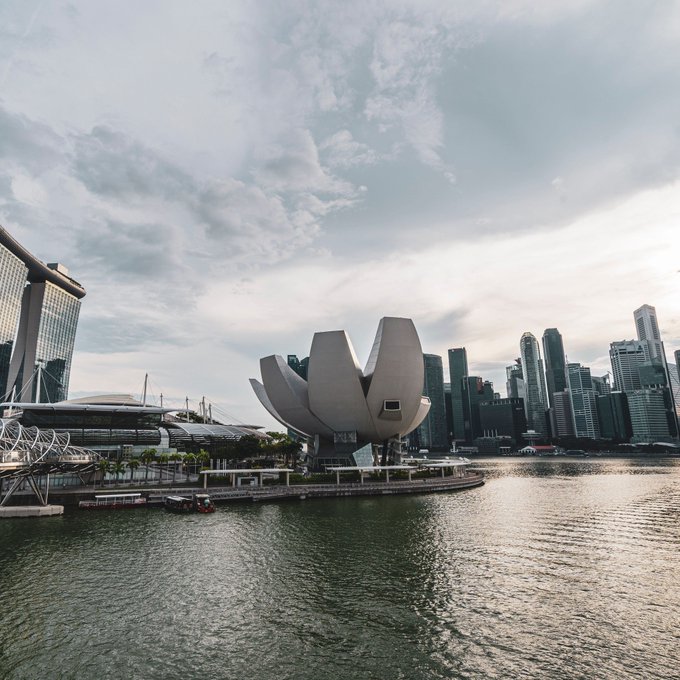 A photo of the ArtScience Museum and Marina Bay Sands in Singapore, with the city skyline in the background. The accompanying post about Singapore's $284 billion crypto activity reflects the country's growing status as a major financial and technology hub in Asia.