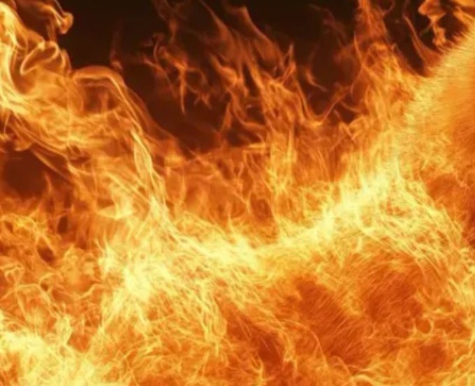 A close-up photograph shows intense orange and yellow flames with swirling smoke patterns.