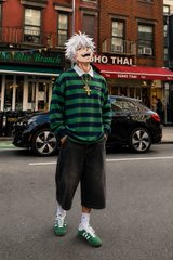 A person with white hair wearing a green striped shirt and green shorts stands on a city street in front of a "NO THAI" sign, with the caption sending goodnight wishes to crypto friends while highlighting $ANSEM's strong $266M market cap.