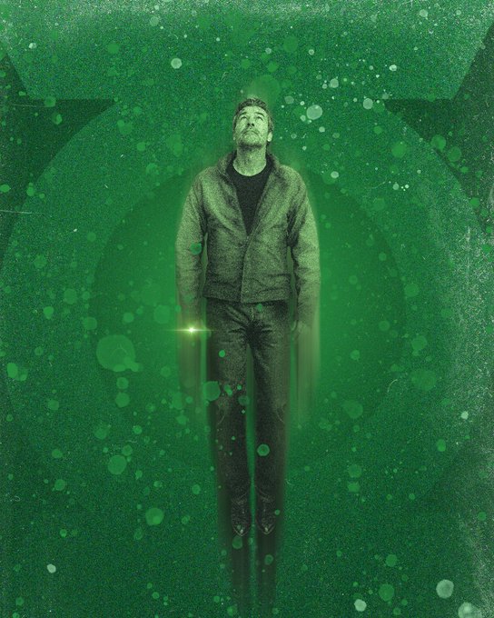 A green-toned artistic poster showing a man standing in a meditative pose, looking upward, with a glowing aura and bubble-like particles around him.