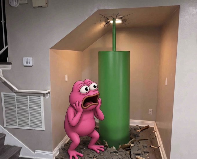 A pink cartoon frog character with a shocked expression stands inside a house next to a tall green pipe that has crashed through the ceiling, surrounded by debris.