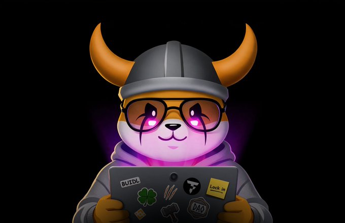 A cartoon Shiba Inu dog wearing a Viking helmet and purple-tinted glasses, holding a laptop with stickers including 'BUIDL', a clover, 'DAO', and 'Lock in'.