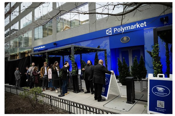 A crowd waits in line outside a blue building with 'Polymarket' signage, where people are entering through a tented entrance during what appears to be a 'Mobilizing the Markets' event.