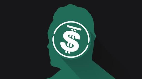 A green silhouette of a person's head with a white circle inside containing a stylized dollar sign icon, set against a dark gray background.