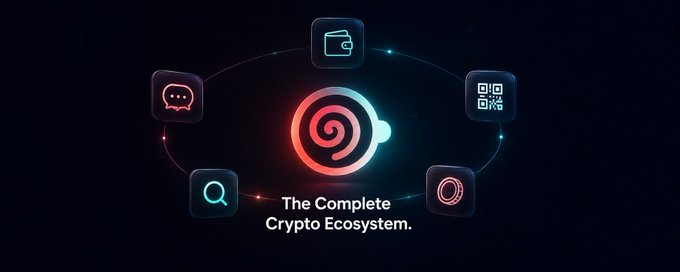 The image features an advertisement for a cryptocurrency called @mocadotapp, which is part of a larger crypto ecosystem. The main focus of the image is a red spiral logo surrounded by various icons representing different aspects of the crypto world. These icons include a wallet icon, a file icon, and a chat icon. The text in the image reads: "The complete crypto ecosystem." This suggests that @mocadotapp offers a comprehensive solution for users interested in cryptocurrency trading or investing.