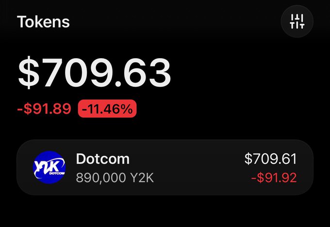 A digital portfolio display showing "Tokens" at $709.63, down 11.46% (-$91.89), with a holding listed as "Dotcom 890,000 Y2K" at $709.61.