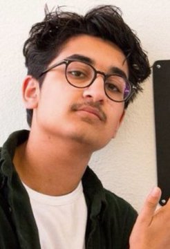 A young man with glasses takes a mirror selfie with his phone, posing with a slight smirk, while the post references the meme coin "$PAID" reaching a $27.1M market cap after FrankDeGods' exit, urging viewers to learn to hold.