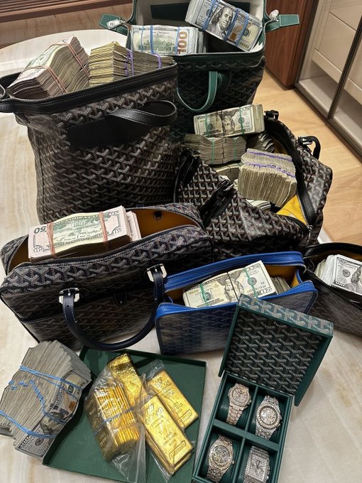 A lavish display of Goyard handbags overflowing with banded stacks of $50 and $100 bills, gold bars, and diamond-encrusted luxury watches in a presentation case—visualizing the ultimate "big money era" fantasy.