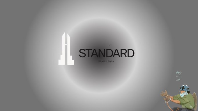 A "STANDARD - COMING SOON" logo with a circular eclipse design is displayed alongside an illustration of a man and woman drinking, while the post announces that $STANDARD isn't live yet and directs users to check the whitelist at standardreserve.xyz.