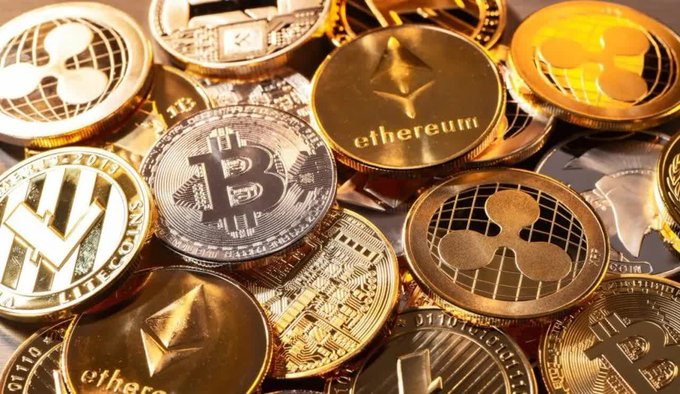 A collection of gold and silver commemorative coins representing various cryptocurrencies, including Bitcoin, Ethereum, Litecoin, and Ripple (XRP).