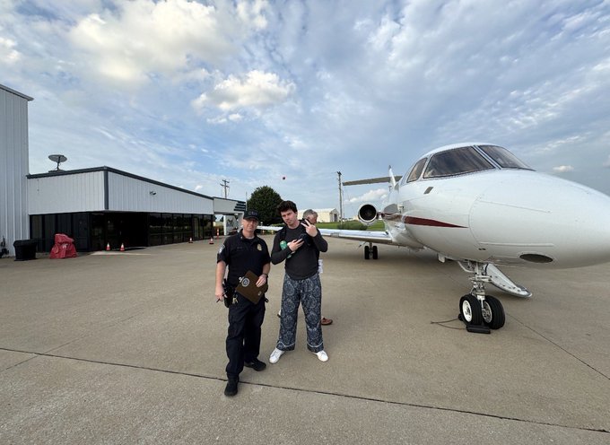 A man stands on an airport tarmac next to a private jet while holding up cash, posing with uniformed crew members in front of the aircraft. The image illustrates the post's boastful tone about closing deals and securing wealth, contrasting with the speculative $SYN penny stock promotion claiming a "generational buying opportunity."