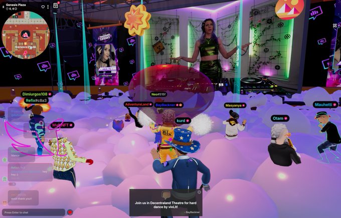 The image shows a group of people standing around inside a virtual room, which appears to be a party or gathering. The room has purple walls with neon lights hanging from them, creating an immersive atmosphere. There are several people present, some wearing costumes that add to the festive ambiance. A large red balloon is prominently displayed in the center of the room, drawing attention and contributing to the lively scene. The post on social media encourages users to join a virtual party or event by sharing their experiences with the image.