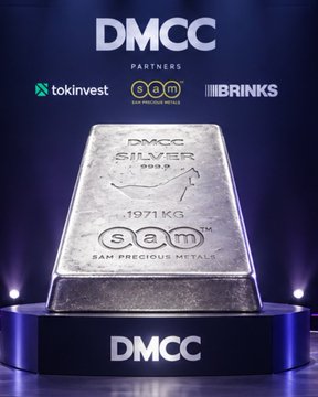 A promotional graphic displays a silver bar engraved with "DMCC SILVER .999 FINE 1971 KG" and "sam SAM PRECIOUS METALS," with logos for DMCC, Tokinvest, and Brinks above it.