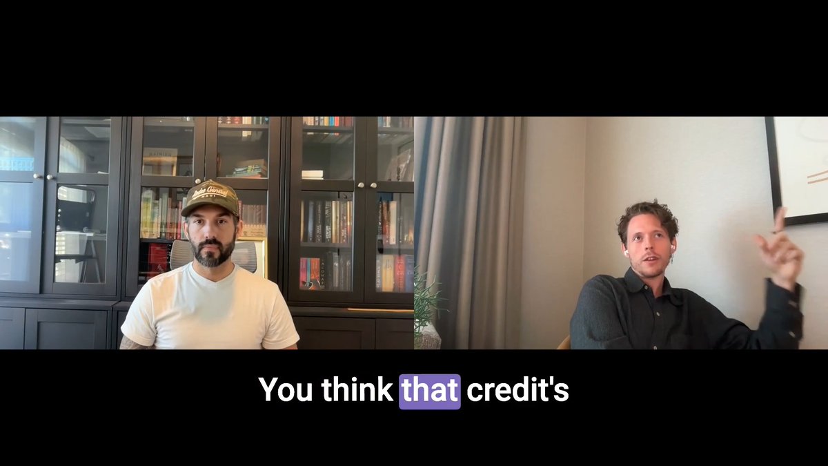 A split-screen video interview features a bearded man in a cap on the left and a curly-haired man gesturing with his finger raised on the right, with subtitles reading 'You think that credit's'.