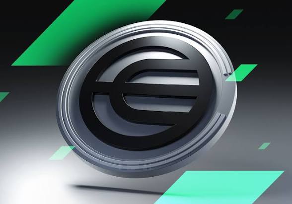 A stylized 3D rendering of the Worldcoin (WLD) logo—a silver coin featuring its signature "W" symbol—floats against a dark backdrop accented with green geometric shapes, visually reinforcing the post's discussion of WLD's price recovery to the $0.40 level.