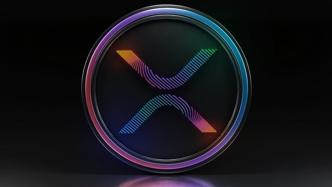 A 3D rendering of the XRP (Ripple) cryptocurrency logo featuring a stylized X symbol with gradient colors inside a circular metallic frame against a dark background.
