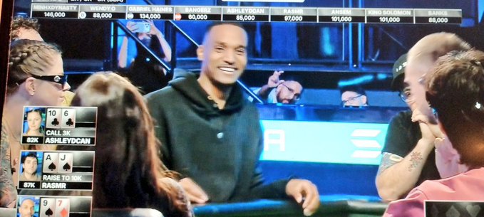 A man smiles at a poker table during a televised game, with on-screen graphics showing players' chip counts and cards, while the caption celebrates daily consistency and conviction behind the Solana token $ANSEM.