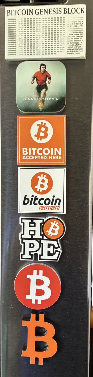 A vertical strip of Bitcoin-themed stickers including the 'Bitcoin Genesis Block', 'Running Bitcoin', 'Bitcoin Accepted Here', 'bitcoin preferred', an 'HPS' logo with Bitcoin symbol, and large orange Bitcoin logos.