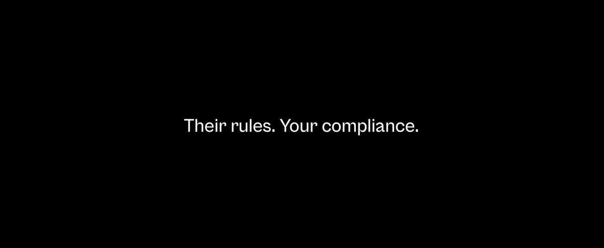 The image features a gray background with white text that reads "Their rules. Your compliance." The text is positioned at the top of the frame, making it the main focus of the image. Below this, there's an image of a person holding a wallet containing Bitcoin and a bank card. This image is related to the post because it highlights how users can now access permissionless money through Bitcoin Layer 1 or permissionless loans on Ducat's mobile app. The combination of these two elements emphasizes the idea that users can easily obtain funds without needing traditional banking systems, which is central to the concept of Bitcoin as a peer-to-peer currency system.