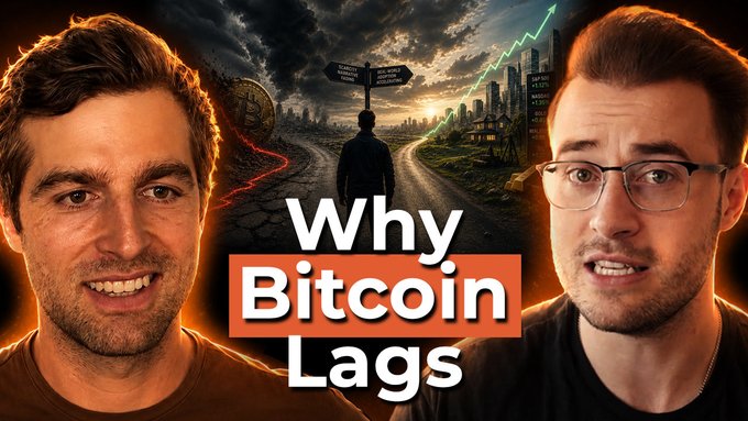 The image features two men standing next to each other, with one man wearing glasses and the other wearing a black shirt. They are both smiling at the camera. The background of the image shows an orange glow, possibly from a neon sign or a light source. Above them, there is text that reads "Why Bitcoin Lags". Below this text, there is another line of text that says "Great podcast I filmed yesterday. Give it a watch if you want to understand why Strategy selling 32 BTC is bullish long-term". The image seems to be related to the topic of Bitcoin and its value.