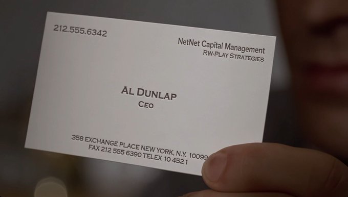 A hand holds up a business card for Al Dunlap, CEO of NetNet Capital Management, featuring the phone number 212.555.6342 and a New York exchange address, which appears to be a reference card for an upcoming NFT collection drop themed around Dunlap as the "Chief Executive Officer 1/1" character.