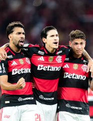 Three Flamengo soccer players, wearing the club's iconic red and black striped jerseys sponsored by "Betano" and "BRB," celebrate together on the pitch with intense expressions of joy. The "Forget™️" caption suggests the image captures a triumphant moment—likely a goal or major win—that opponents will find impossible to erase from memory.