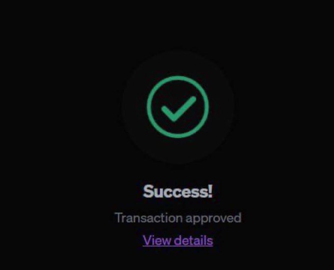 Dark screen displaying a green checkmark with the text 'Success!' and 'Transaction approved' along with a 'View details' link.