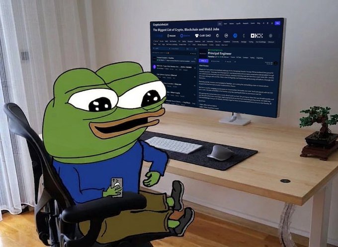 A Pepe the Frog cartoon character sits casually at a minimalist desk in front of a curved monitor displaying CryptoJobList with "Principal Engineer" listings and logos for Wallet, CoW DAO, and OKX. The meme ties into the "GM!" post by giving a cheerful morning greeting vibe, fitting the laid-back crypto community culture.