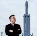 A man in a suit stands with arms crossed in front of a large rocket on a launch pad. The image evokes Elon Musk and SpaceX's space ambitions, which the post uses as a metaphor for a stock's multi-phase price trajectory, comparing the company's long-term roadmap to a trading plan moving through IPO pump, distribution, unlock flush, and smart money entry phases.