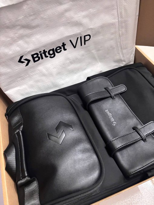 A close-up view of an unboxed VIP gift set from Bitget, featuring a black branded pouch with the Bitget logo and a matching accessory holder, alongside a dust bag printed with "Bitget VIP." The image showcases the premium merchandise being prepared for the Bitget Thanks Web3 celebration.