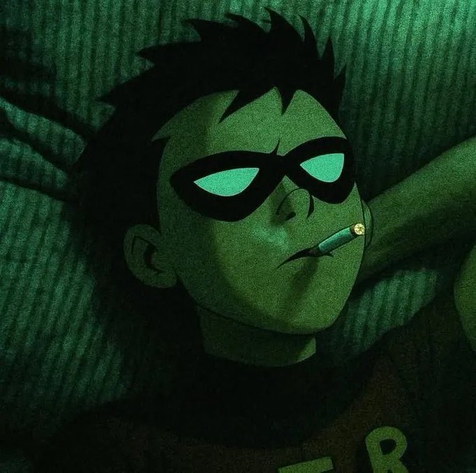 A stylized illustration of a young man with messy dark hair, wearing a black domino mask with glowing green eyes, smoking a cigarette in a green-tinted scene.
