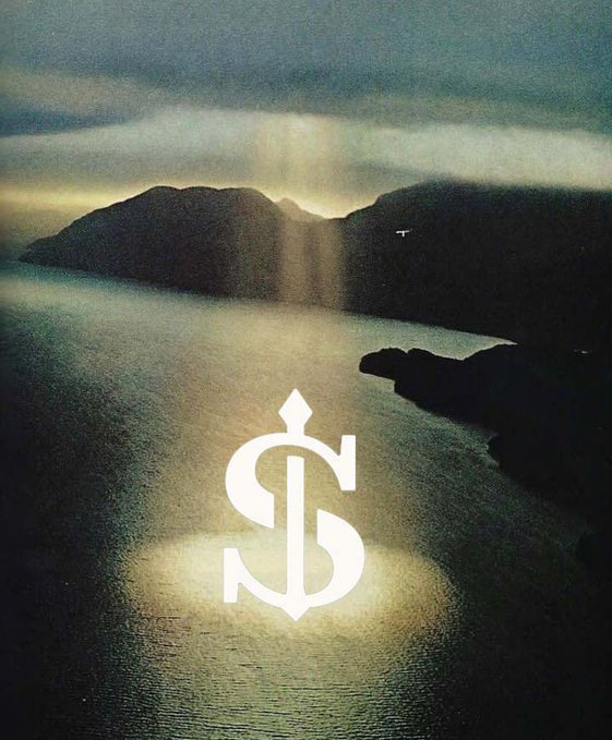 Artistic photo of a dramatic seascape with sun rays breaking through clouds over dark mountains and water, overlaid with a white dollar sign ($) logo in the center.