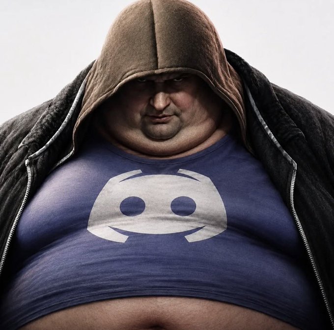 A heavily overweight man wearing a brown hoodie partially unzipped over a blue shirt featuring the Discord logo, staring menacingly at the camera.