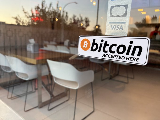 A "bitcoin ACCEPTED HERE" sticker is displayed on the window of Double B burger restaurant in Caserta, marking the historic first Bitcoin payment in the region via BTCPay Server and Arkade wallet.