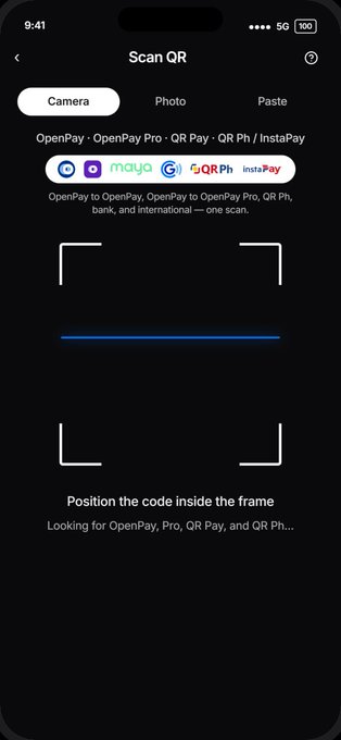 The image shows a mobile QR scanner screen with the title "Scan QR" and options for Camera, Photo, and Paste. It displays supported payment methods including OpenPay, OpenPay Pro, QR Pay, QR Ph, InstaPay, and Maya, with the instruction "Position the code inside the frame" to align with OpenPay's enhanced scanning experience.