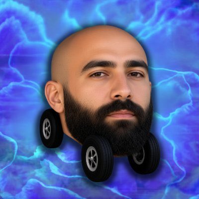 A surreal digital image depicts a bearded, bald man's head mounted on four black wheels, set against a vibrant blue rippled background.