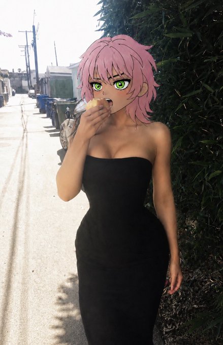 An anime-style character with pink hair and green eyes wearing a black strapless dress, eating a piece of bread outdoors near a hedge on a sunny day.