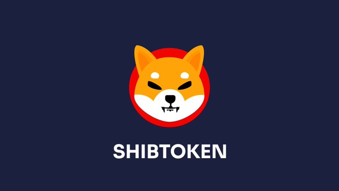 The image displays a stylized logo featuring a Shiba Inu dog's face within a red circle on a dark navy background, with "SHIBTOKEN" written in white text below it. This logo visually represents the $SHIB cryptocurrency being discussed in the post, which highlights the meme coin's sudden 36% price rally driven by South Korean traders despite the absence of any clear catalyst.