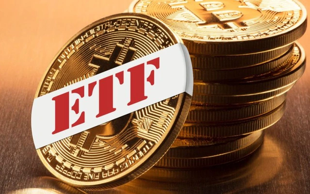 A stack of gold Bitcoin coins with the front coin labeled 'ETF' in red letters on a white banner, resting on a wooden surface.