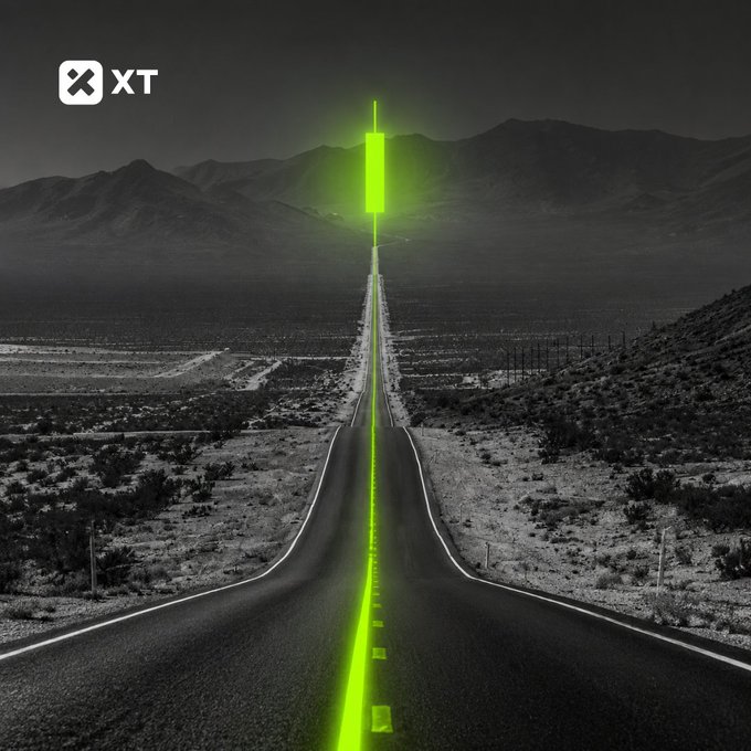 A long, empty highway stretches toward dark mountains, illuminated by a glowing green candlestick in the distance that resembles a horizontal "doji" or paused bar. The "XT" exchange logo appears in the top-left corner, visually reinforcing the post's message about an unchanged rate amid shifting market conditions for BTC.